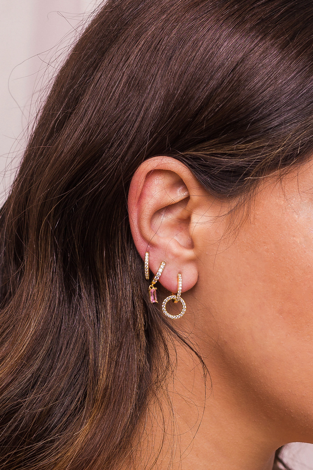 Woman Ear with Mulriple Piercings Wearing Beautiful Earrings Wit