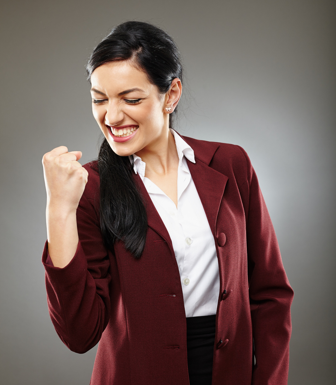 Excited Woman in Businesswear Posing with a Closed Fist 